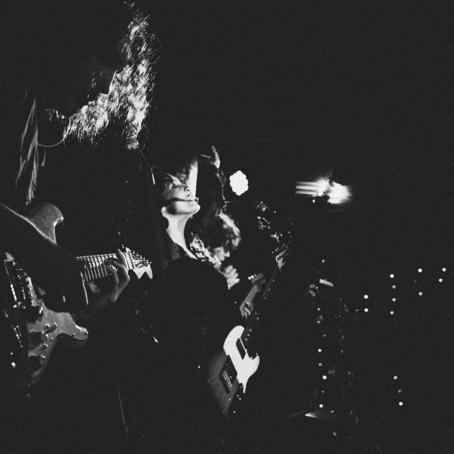 Heidi Curtis singing on stage in black and white concert photography