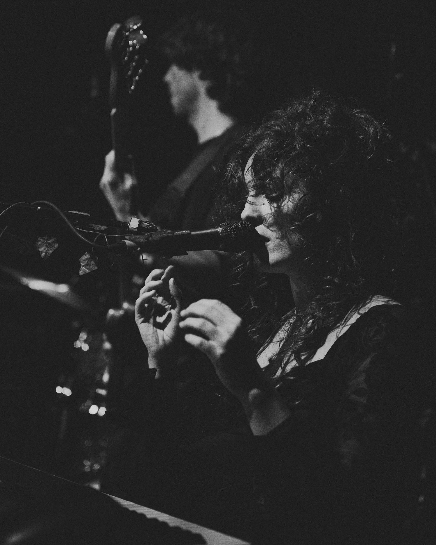 Moody black and white image of Heidi Curtis performing live