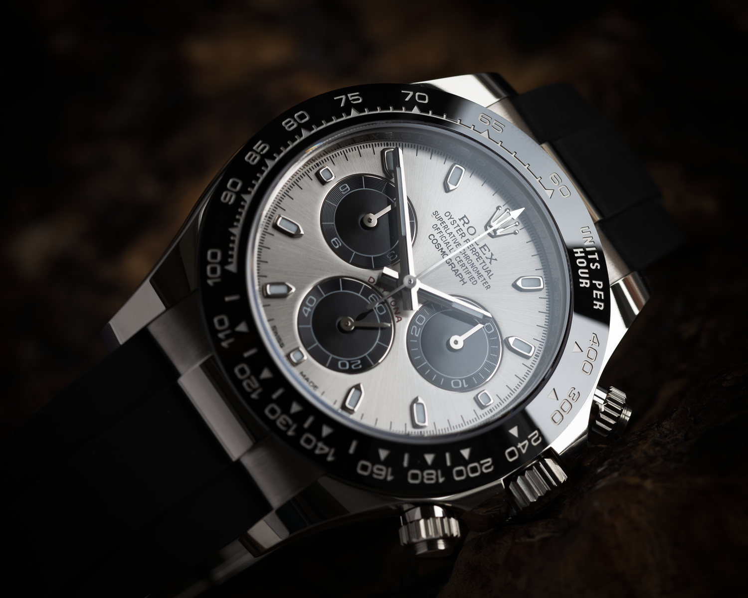 rolex daytona cosmograph photographed on a wooden background