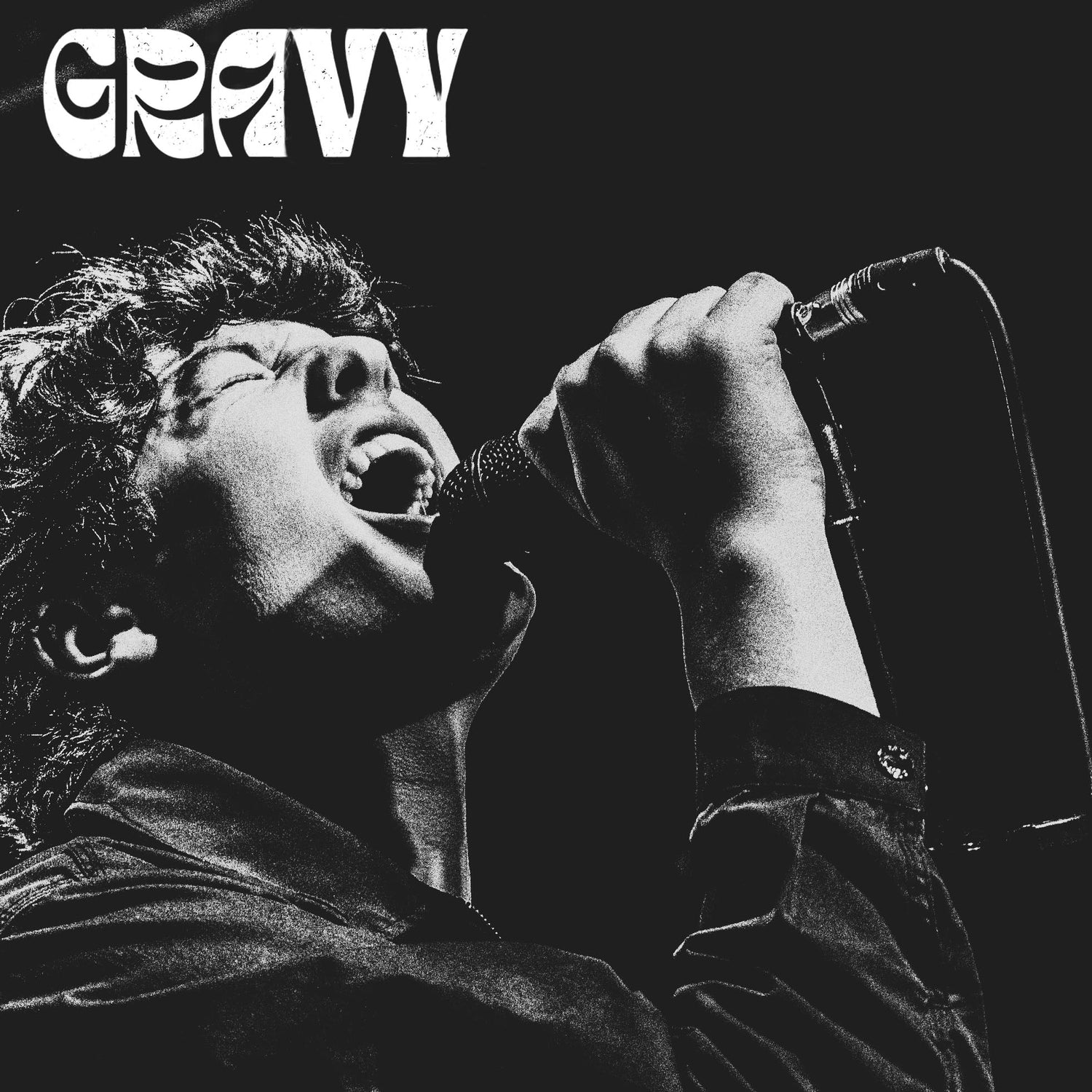 Harrison Bailey from the band Gravy singing down the microphone