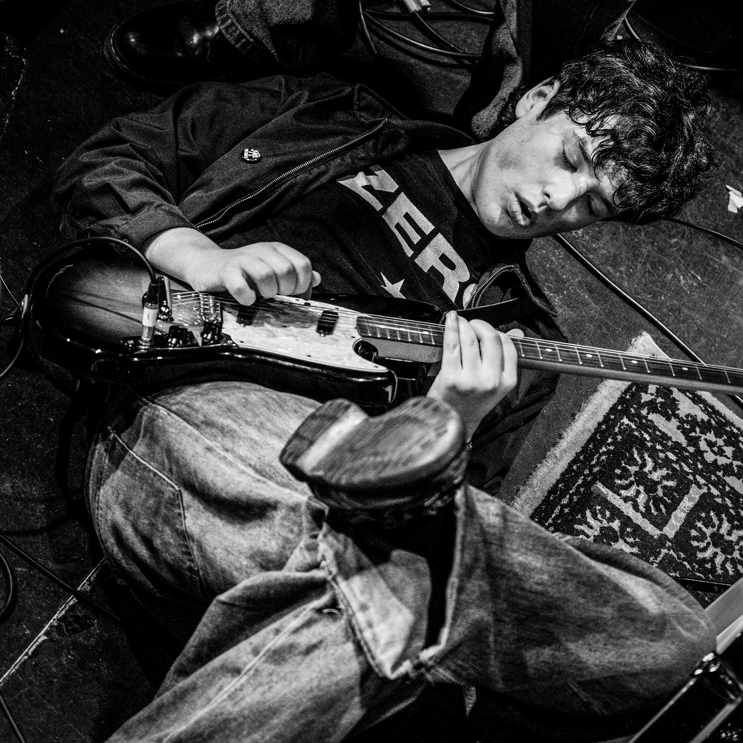 Harrison Bailey playing guitar whilst lying on the floor - The Cluny, Newcastle