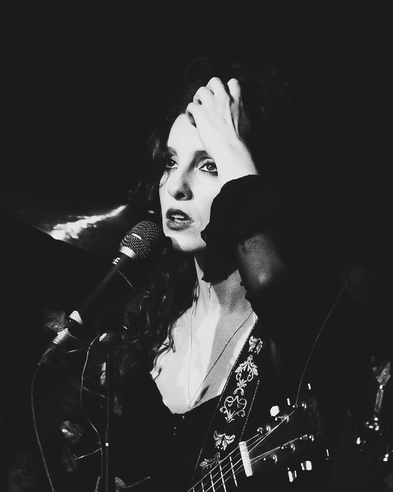 Atmospheric black and white portrait of singer Heidi Curtis live on stage