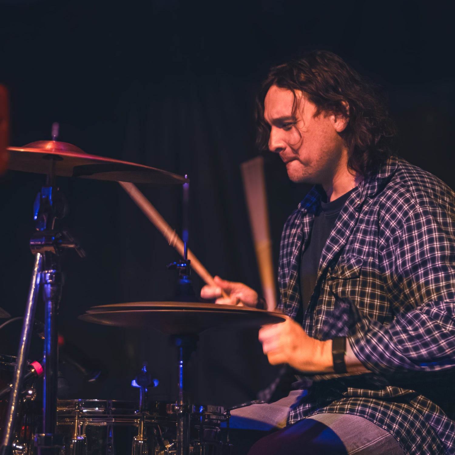 Drew Michael from Sam Fender Playing Drums on a dark stage at The Cluny in Newcastle